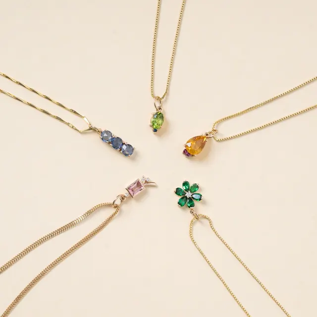 Stunning collection of gold necklaces featuring vibrant gemstone pendants for a luxurious touch.