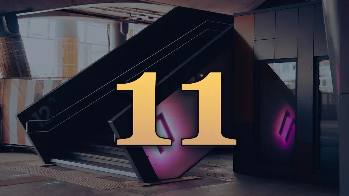 A modern architectural stairway with a glowing neon number 11 sign indoors.